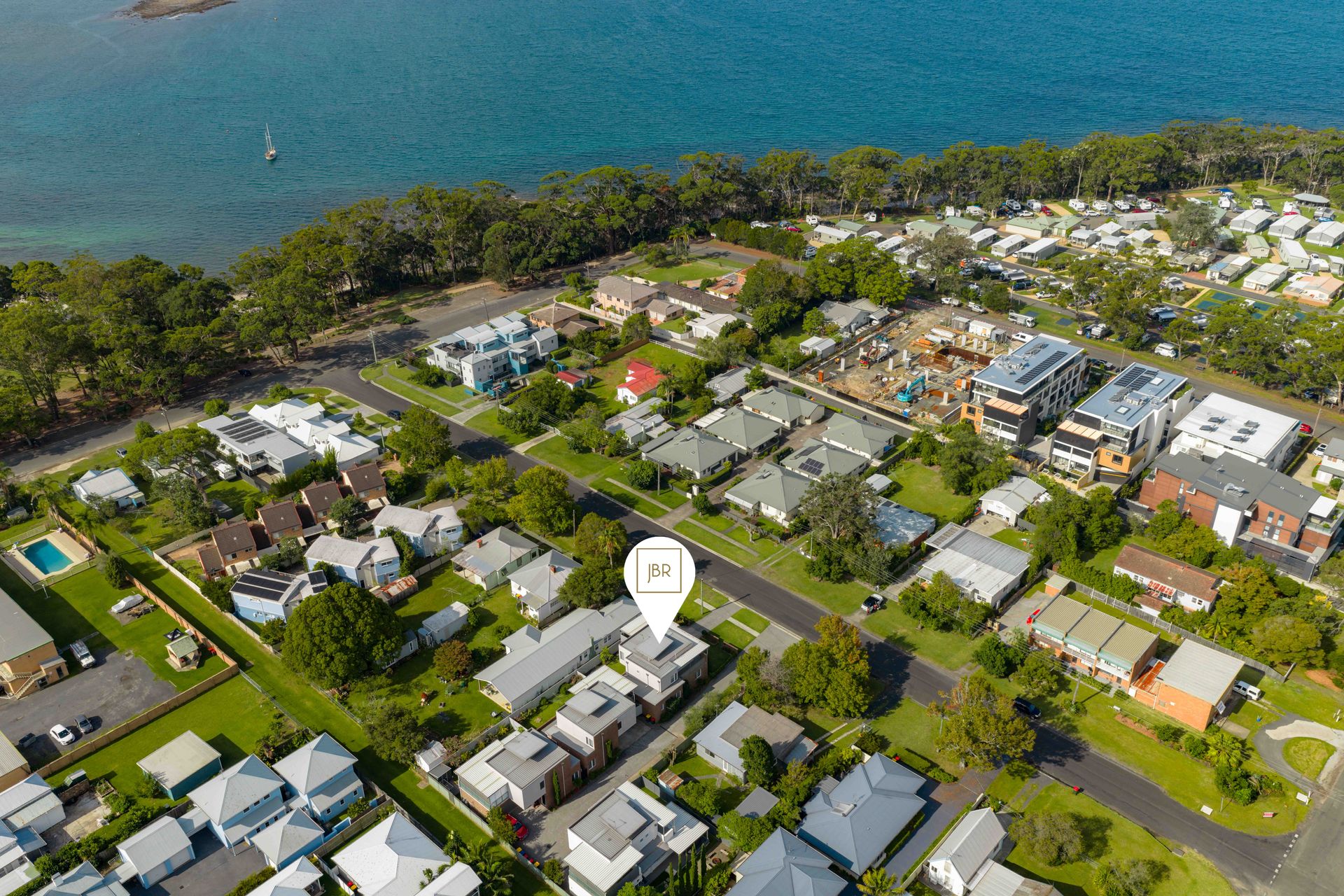 Aerial view of Huskisson showing the streets between the house and the bay