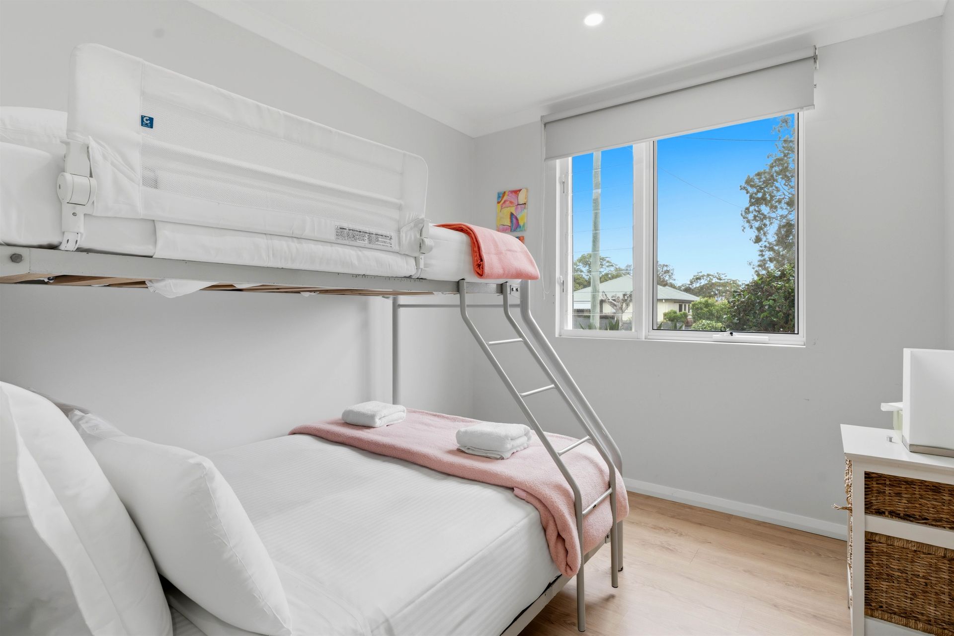 Tri-bunk bedroom with a double bed below and single bunk above