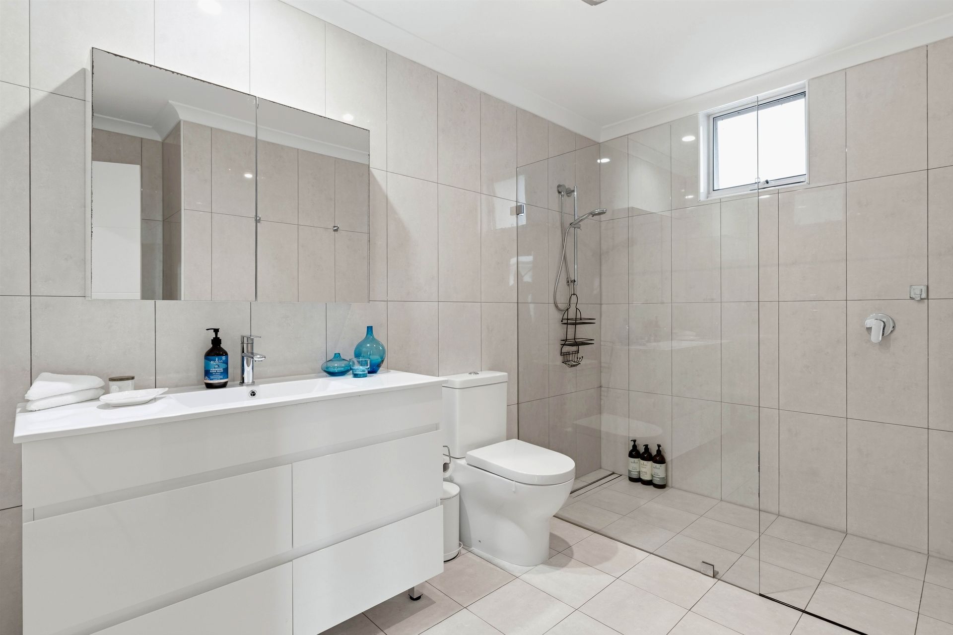 Bathroom with double mirror, wide vanity and walk-in shower