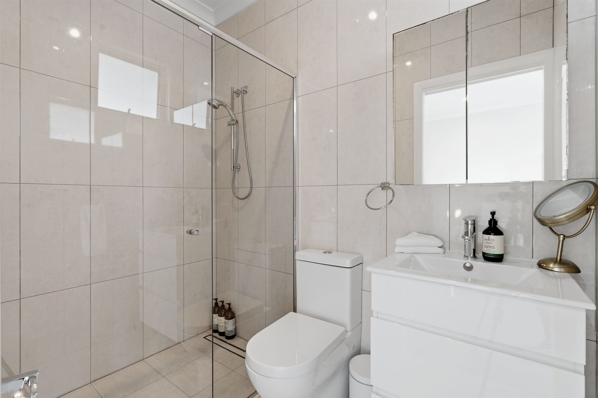 Bathroom with walk-in shower, toilet and vanity storage