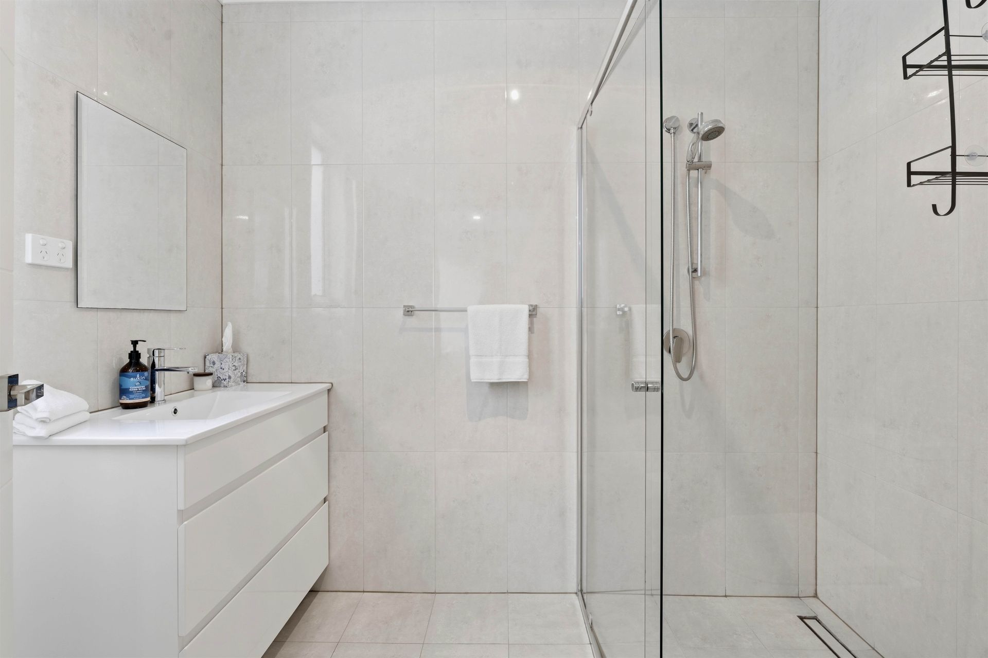 Bathroom with glass shower screen, vanity and mirror