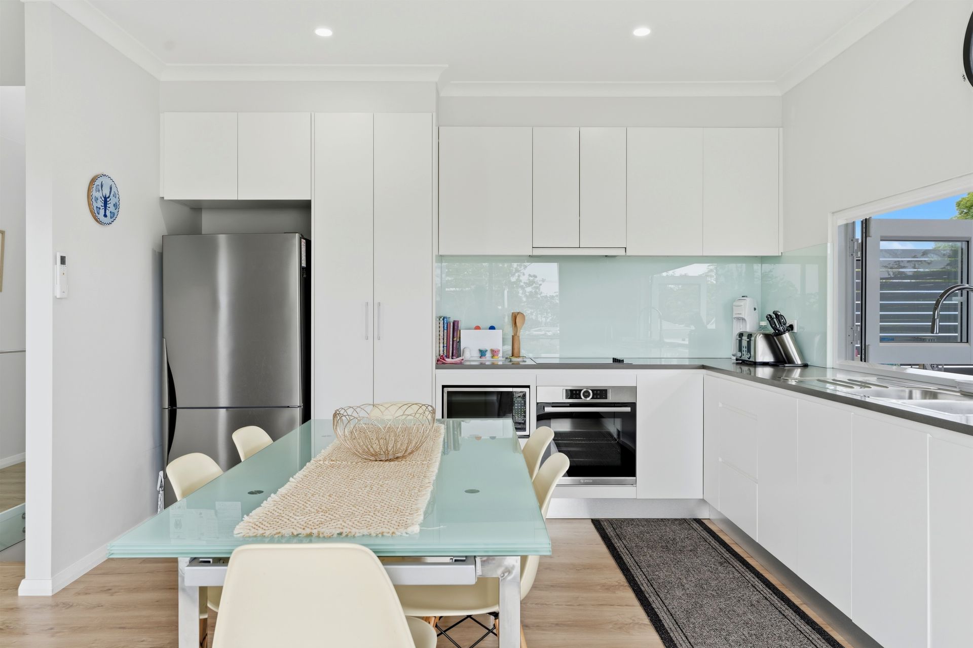 Fully equipped kitchen with stainless steel oven, stove and large fridge